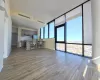 Unfurnished living room with floor to ceiling windows, a wealth of natural light, and light wood-type flooring