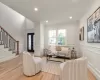 Living room with light oak wood floors and ornamental molding