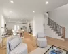 Living room with light oak wood floors and ornamental molding