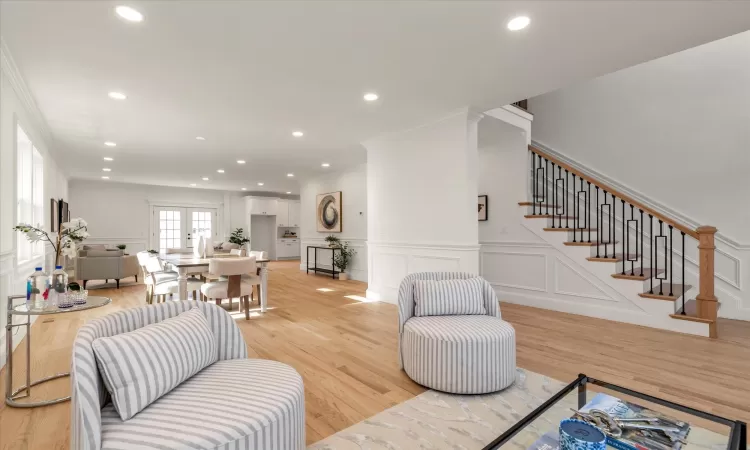 Living room with light oak wood floors and ornamental molding