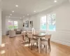 Dining area with crown molding and light oak wood floors