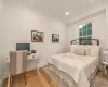 Bedroom with crown molding and light oak  wood floors