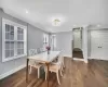 Dining room with dark wood-type flooring and ornamental molding