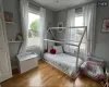 Bedroom featuring light wood-type flooring and multiple windows