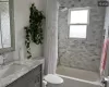 Full bathroom featuring plenty of natural light, toilet, vanity, and shower / tub combo with curtain