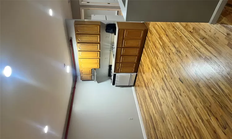 Kitchen with sink, refrigerator, light hardwood / wood-style flooring, and range