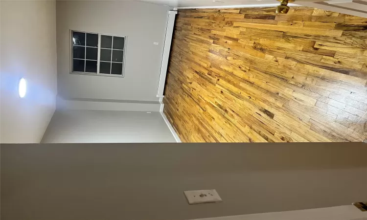 Empty room with baseboard heating and light hardwood / wood-style flooring