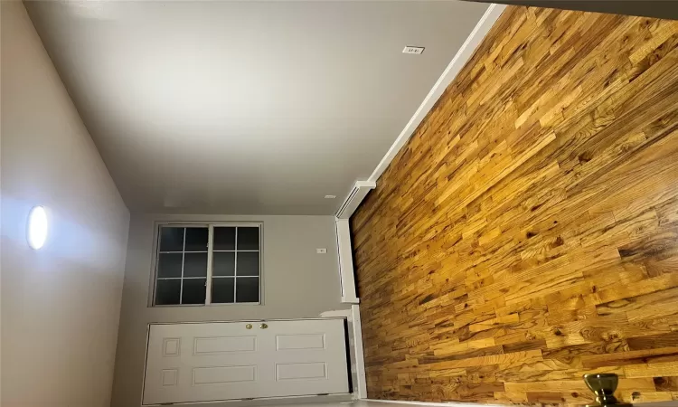 Empty room with light hardwood / wood-style floors and baseboard heating