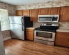 Kitchen featuring light hardwood / wood-style flooring and stainless steel appliances