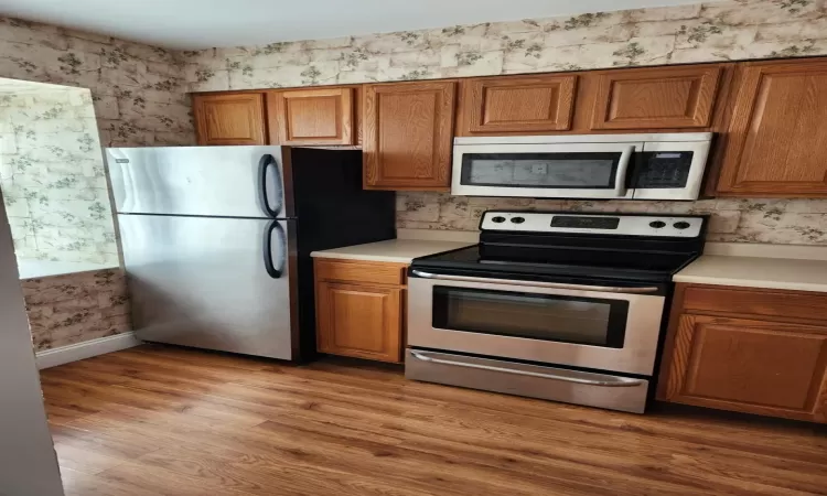 Kitchen featuring light hardwood / wood-style flooring and stainless steel appliances