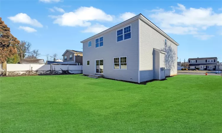 Rear view of property featuring a yard