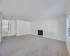 Unfurnished living room with crown molding, plenty of natural light, and light wood-type flooring