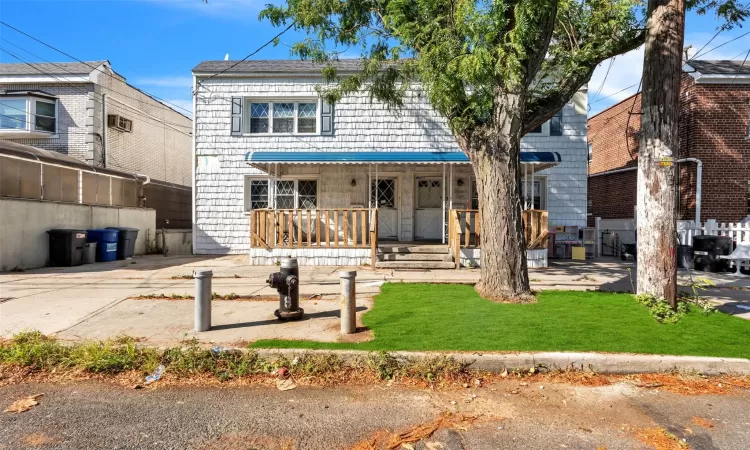 View of front of house featuring covered porch and a front lawn