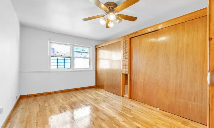 Unfurnished bedroom featuring ceiling fan, light wood-type flooring, and a closet