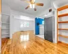 Unfurnished living room featuring washer / dryer, light wood-type flooring, and ceiling fan