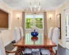 Dining space featuring a notable chandelier, dark hardwood / wood-style flooring, ornamental molding, and baseboard heating