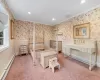 Carpeted bedroom with ornamental molding and a baseboard radiator