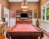 Recreation room with a wealth of natural light, wood-type flooring, indoor bar, and pool table