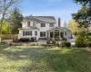 Back of house featuring a lawn and a patio