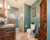 Bathroom with vanity,  a shower with door, tile patterned flooring, and toilet