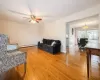 Living room with hardwood / wood-style floors, ceiling fan.