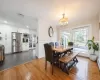 Dining area with a notable chandelier, dark hardwood / wood-style flooring.