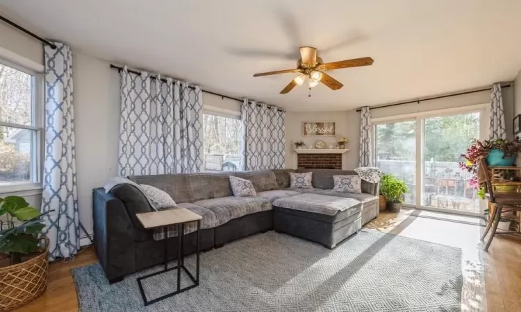 Living room featuring light hardwood / wood-style flooring and ceiling fan