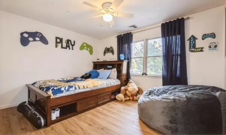 Bedroom featuring hardwood / wood-style floors and ceiling fan