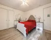 Bedroom featuring light wood-type flooring, ceiling fan, and crown molding