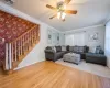 Living room featuring hardwood / wood-style flooring, plenty of natural light, ceiling fan, and ornamental molding