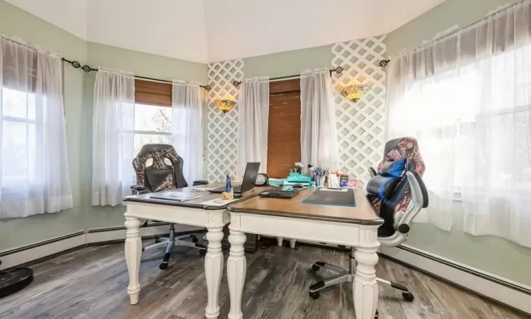 Office space in Primary Bedroom featuring hardwood / wood-style flooring.