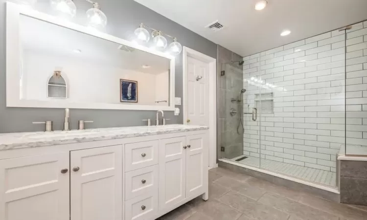 Bathroom with vanity and an enclosed shower