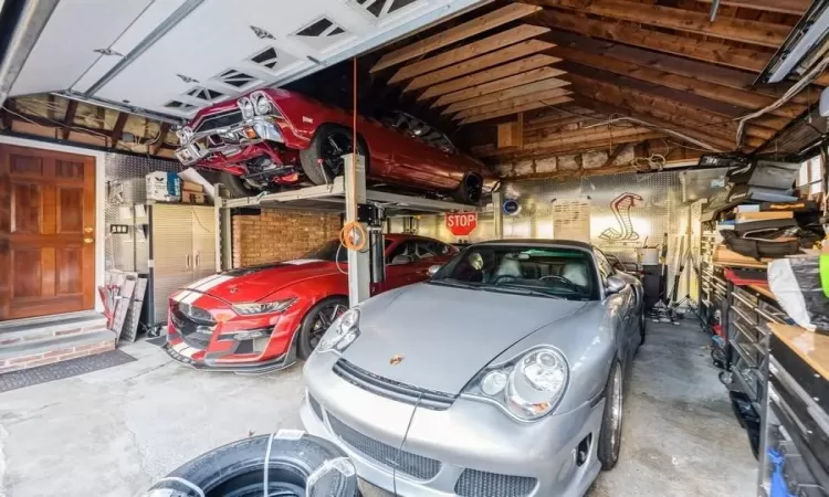 New garage door, diamond point garage walls with car lift that can be moved on wheels.