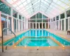 View of swimming pool featuring a patio area and an indoor in ground hot tub