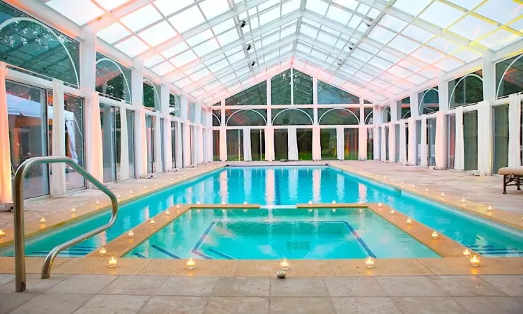 View of swimming pool featuring a patio area and an indoor in ground hot tub