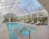 View of pool featuring an in ground hot tub, outdoor lounge area, a lanai, and a patio area