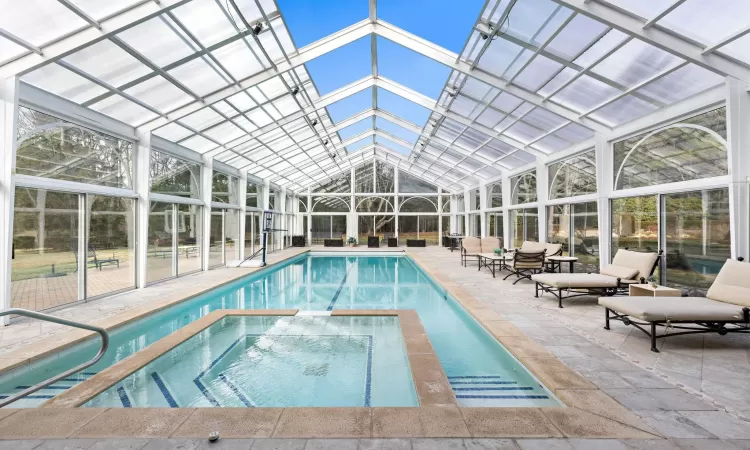 View of pool with an in ground hot tub and a patio