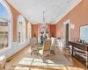 Dining area featuring a notable chandelier, ornamental molding, and light parquet floors