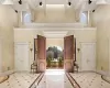 Foyer featuring beamed ceiling and a high ceiling