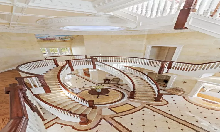 Staircase featuring coffered ceiling