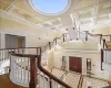 Entrance foyer with wood-type flooring, crown molding, a towering ceiling, and coffered ceiling