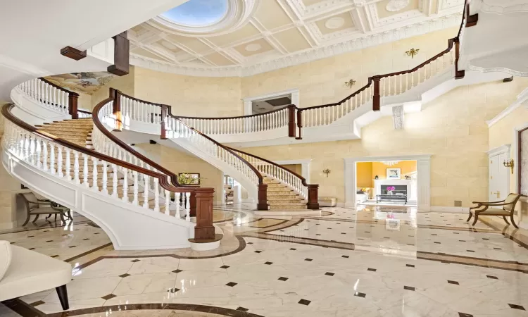 Foyer with a towering ceiling and ornamental molding