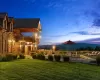 Yard at dusk featuring a mountain view and a balcony