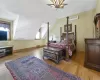 Bedroom with vaulted ceiling, a wall mounted air conditioner, and light wood-type flooring