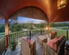 Deck at dusk with outdoor lounge area and a water view