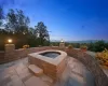 Patio terrace at dusk with an in ground hot tub