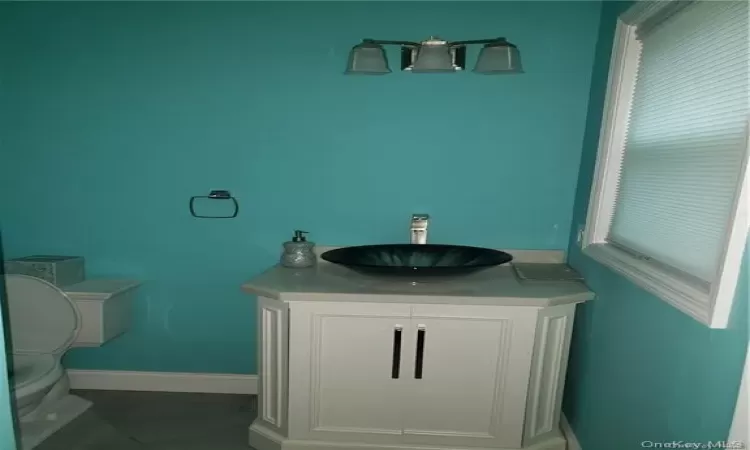 1st fl Bathroom featuring toilet, vanity, and tile patterned floors