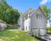 View of property exterior with a lawn and a garage