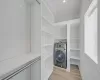 Laundry area with light wood-type flooring and washer / clothes dryer