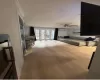 Living room featuring ceiling fan, french doors, crown molding, and light wood-type flooring